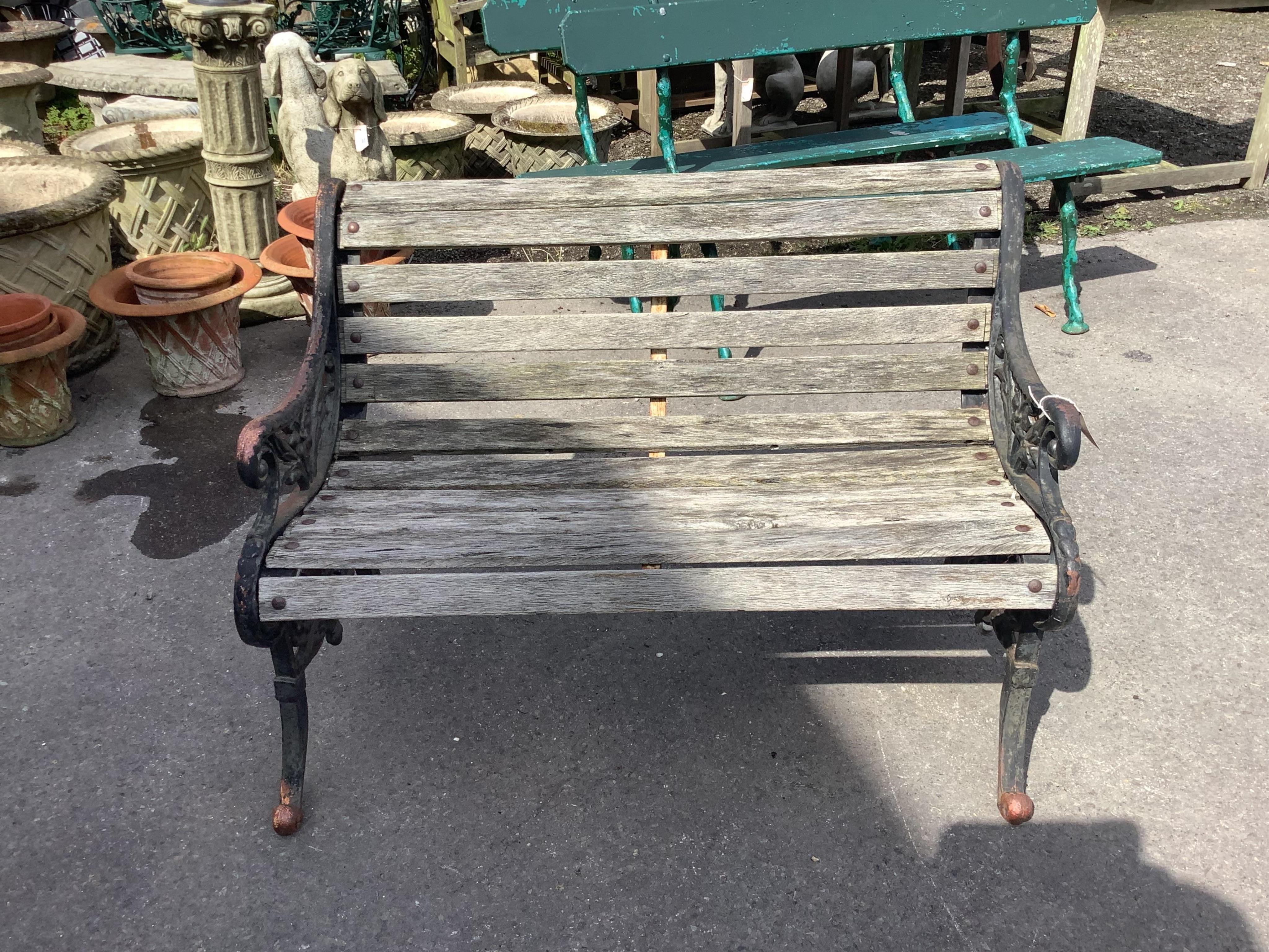 A Victorian style wrought iron slatted garden bench, width 122cm, height 82cm. Condition - fair